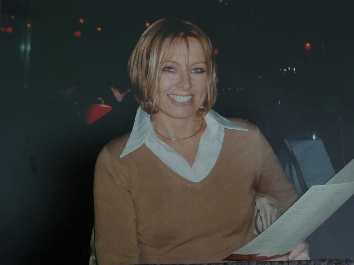 Erica smiling at a table in Paris while living in England, the transformation seemingly complete. She had crossed countries, rebuilt herself and become the polished woman she thought she needed to be, carrying the past quietly beneath the life she had carefully created.
